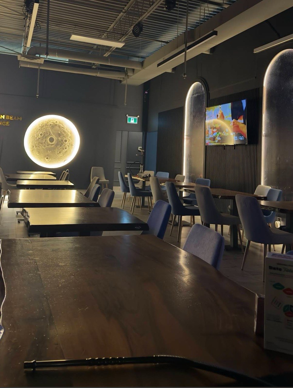 Moonbeam Lounge dining room with its glowing moon wall